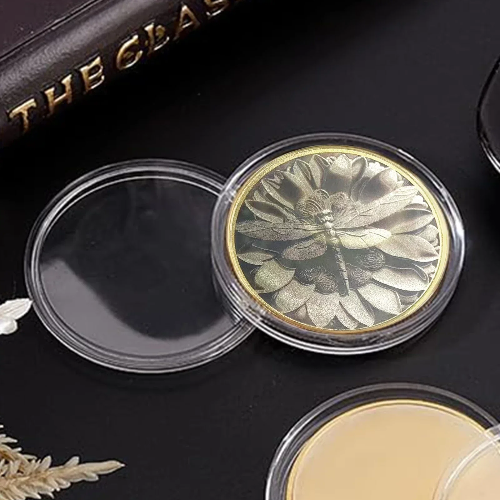 Engraved brass coin inside clear capsule reference